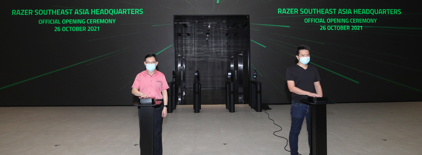 Two masked people at Razer's Southeast Asia Headquarters opening ceremony.